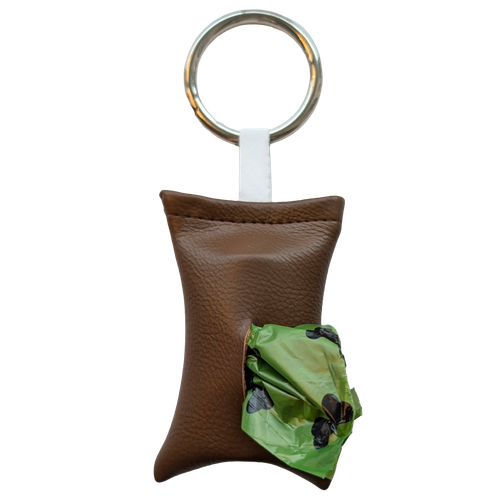 Mocha color poop bag holder in vegan leather, handmade in Stockholm. The pouch features a metal ring and holds one roll of dog waste bags.