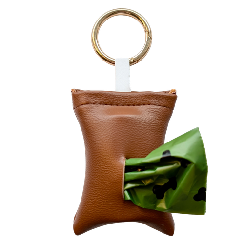Copper color poop bag holder in vegan leather, handmade in Stockholm. The pouch features a metal ring and holds one roll of dog waste bags.